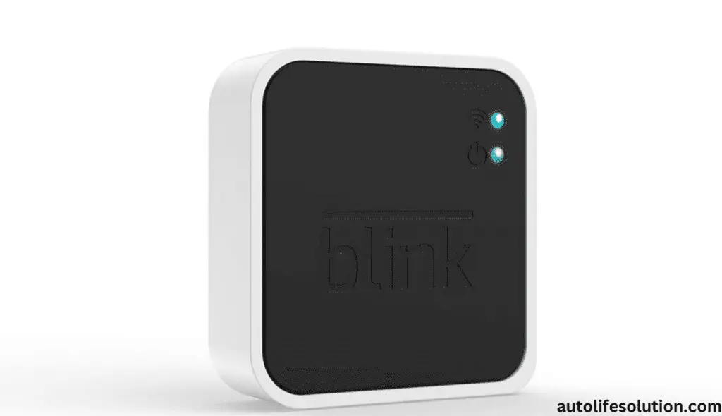 A hand holding a Blink Sync Module with a reset button. Concept of resetting the module to factory settings for troubleshooting and connectivity